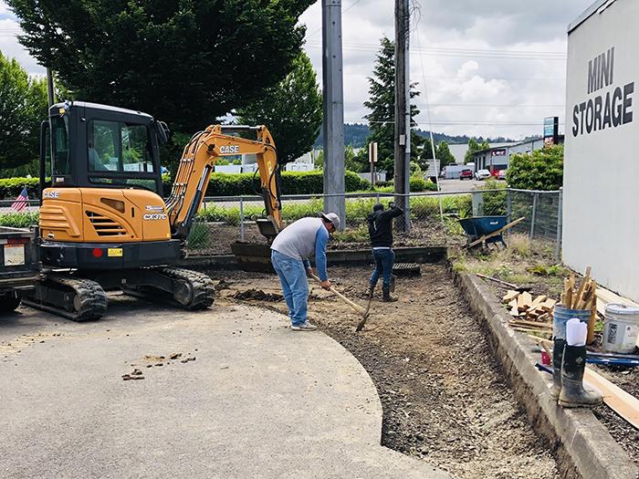 Workers excavate area for a raingarden