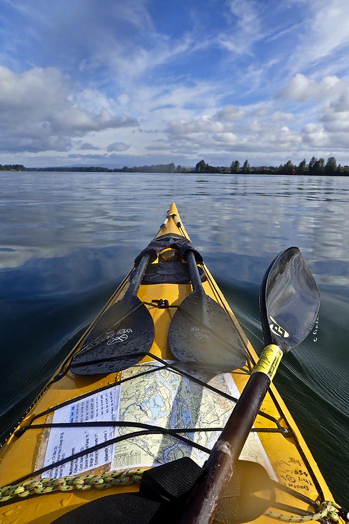 kayak bow on the Columbia River. Strapped on the front are an extra paddle and a map